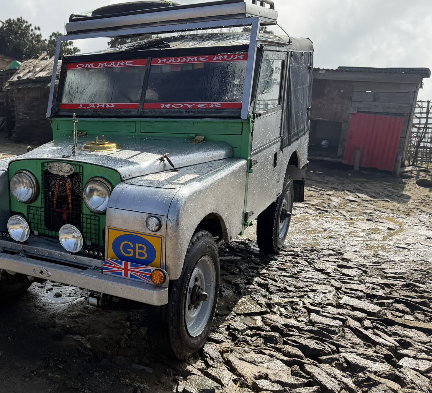 A vintage Land Rover in a mountain village on the road to Singalila National Park