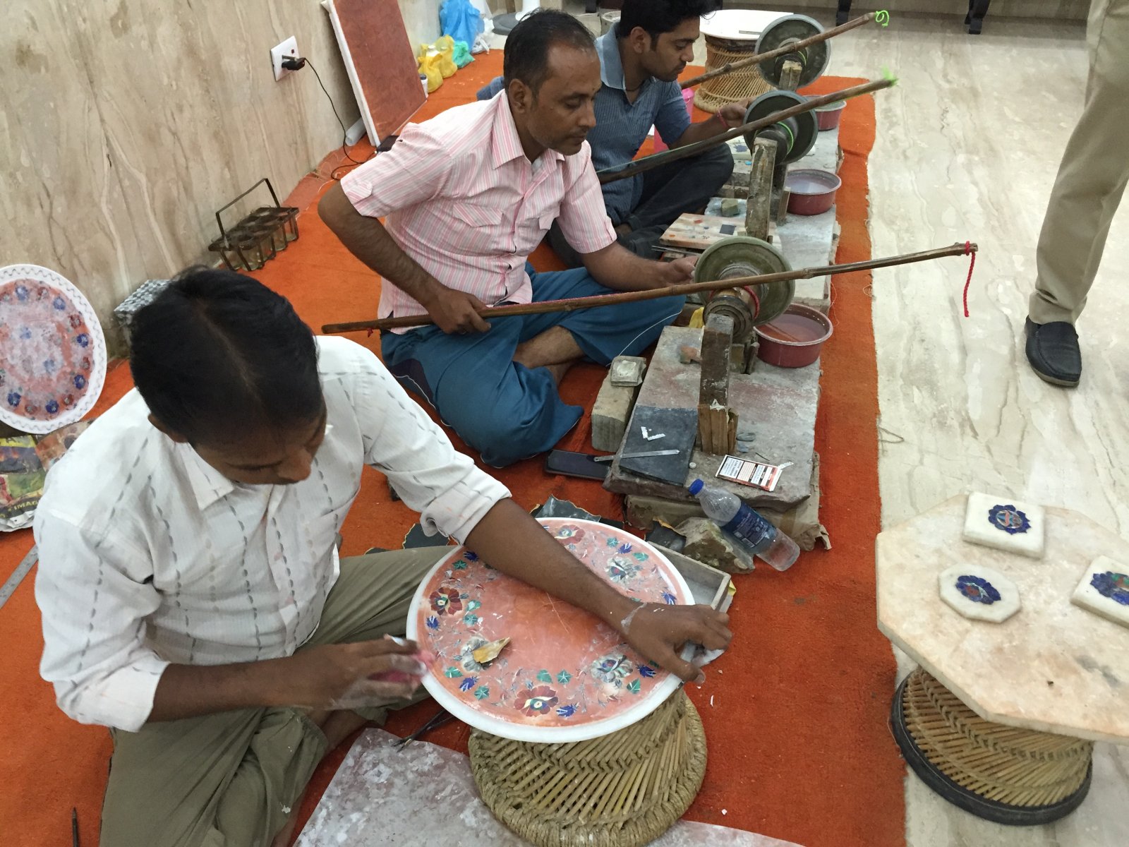 Craftsmen in an Agra workshop setting semi-precious stones into marble by hand, the inlay technique used on the Taj Mahal