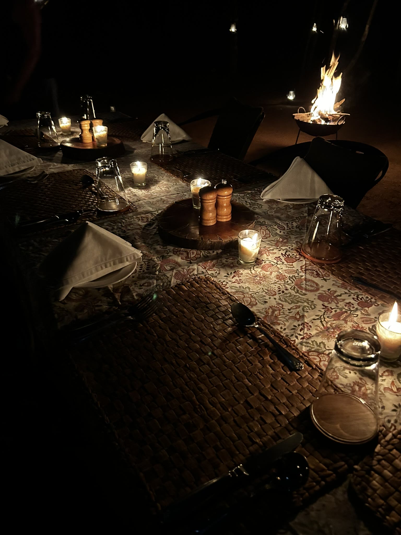 Table set for a private bush dinner by firelight at Pench Tree Lodge