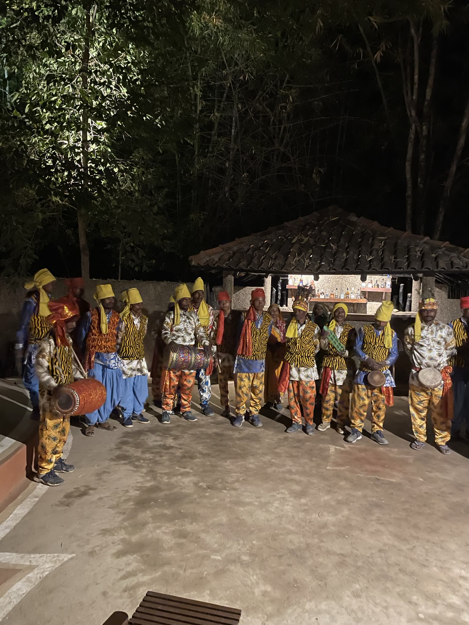 Tribal dancers in traditional dress gathered for an evening performance near Kanha