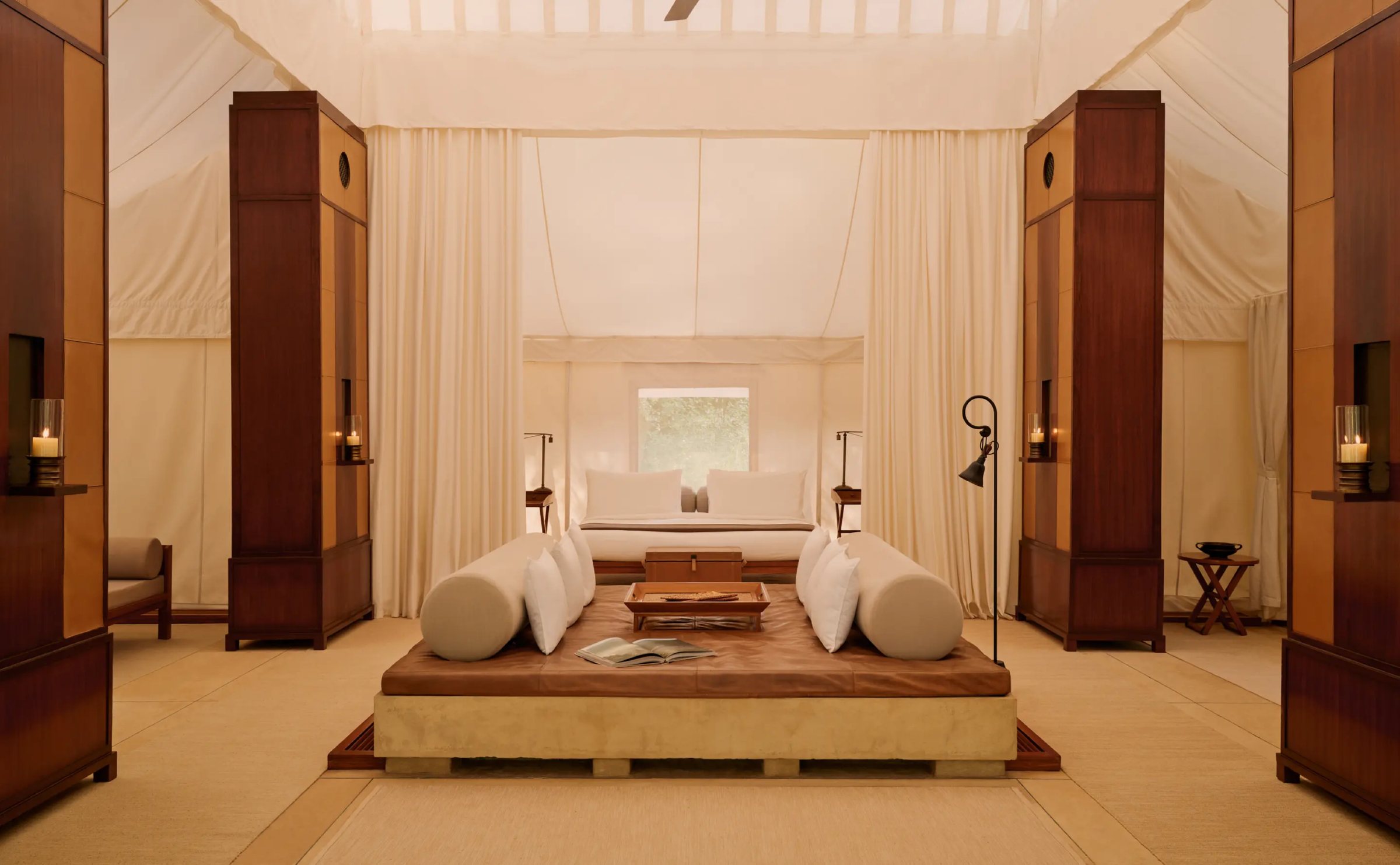 Inside a tent at Aman-i-Khás, with tall wooden cabinets on either side of the bed