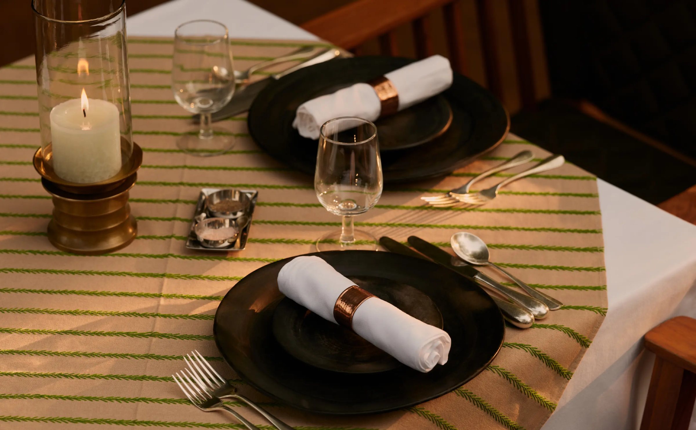 A candle-lit table laid for dinner at Aman-i-Khás