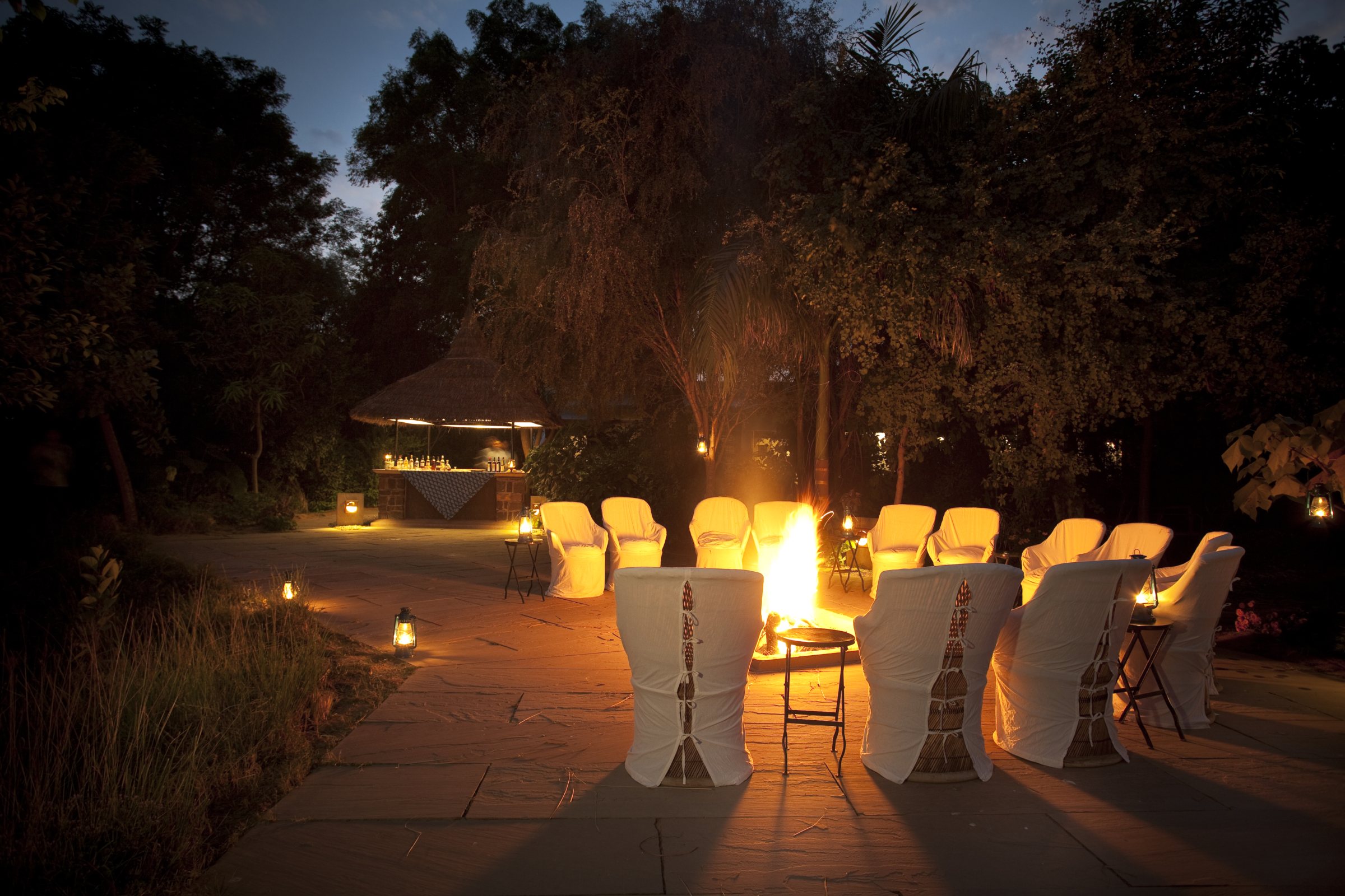 Chairs set around the evening campfire at Khem Vilas