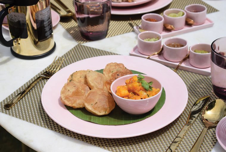 Puris and a mango dish served at Postcard Gir