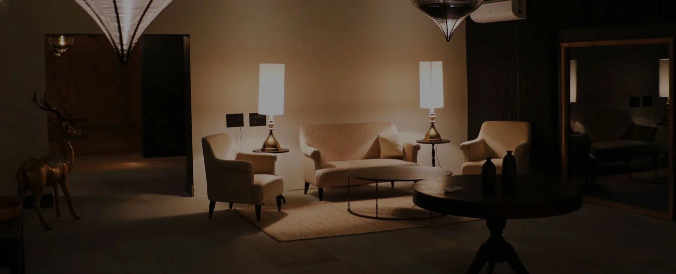 A sitting area with armchairs and tall lamps at Postcard Gir