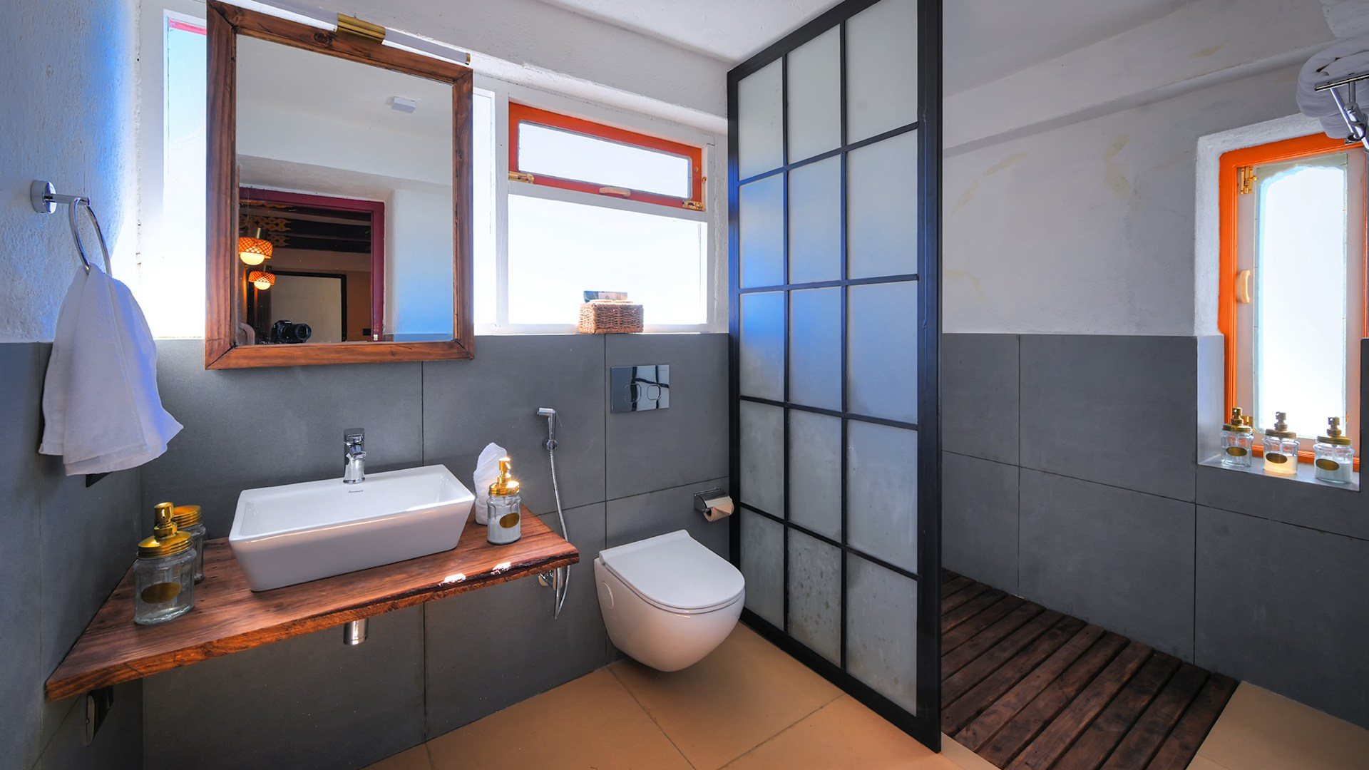 An en suite bathroom at Red Panda Outpost with a glass shower screen