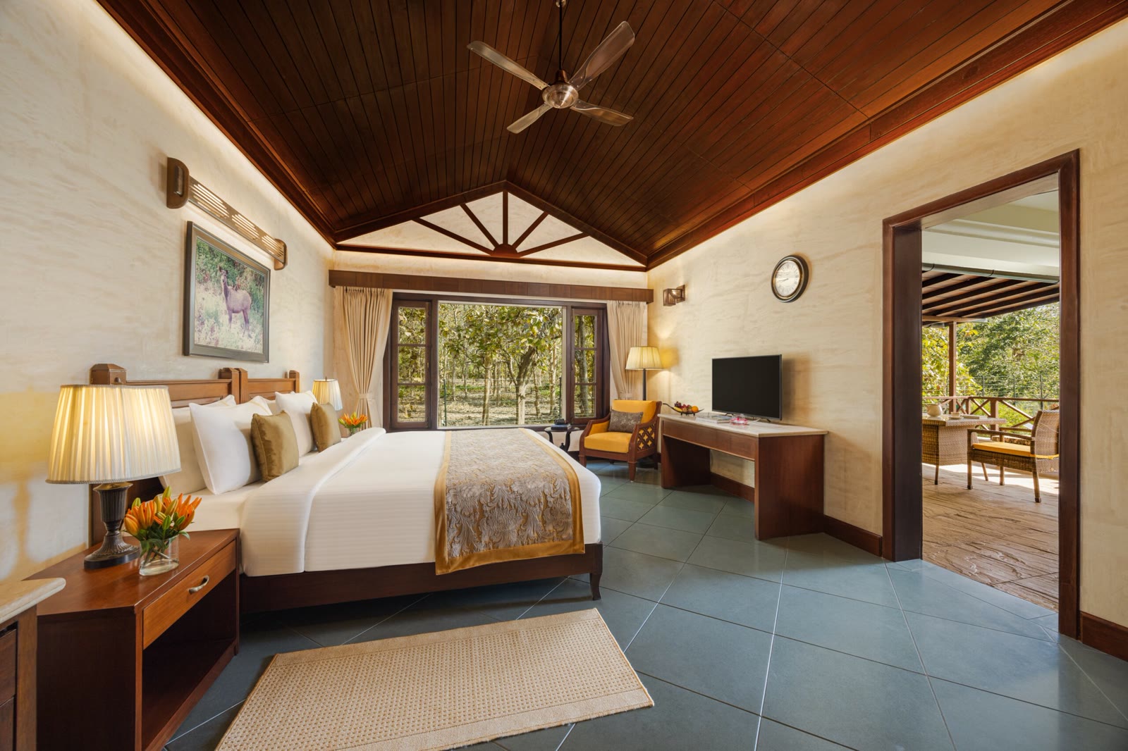 Room at Aahana Resort, Corbett, with a timber ceiling and a window onto the forest