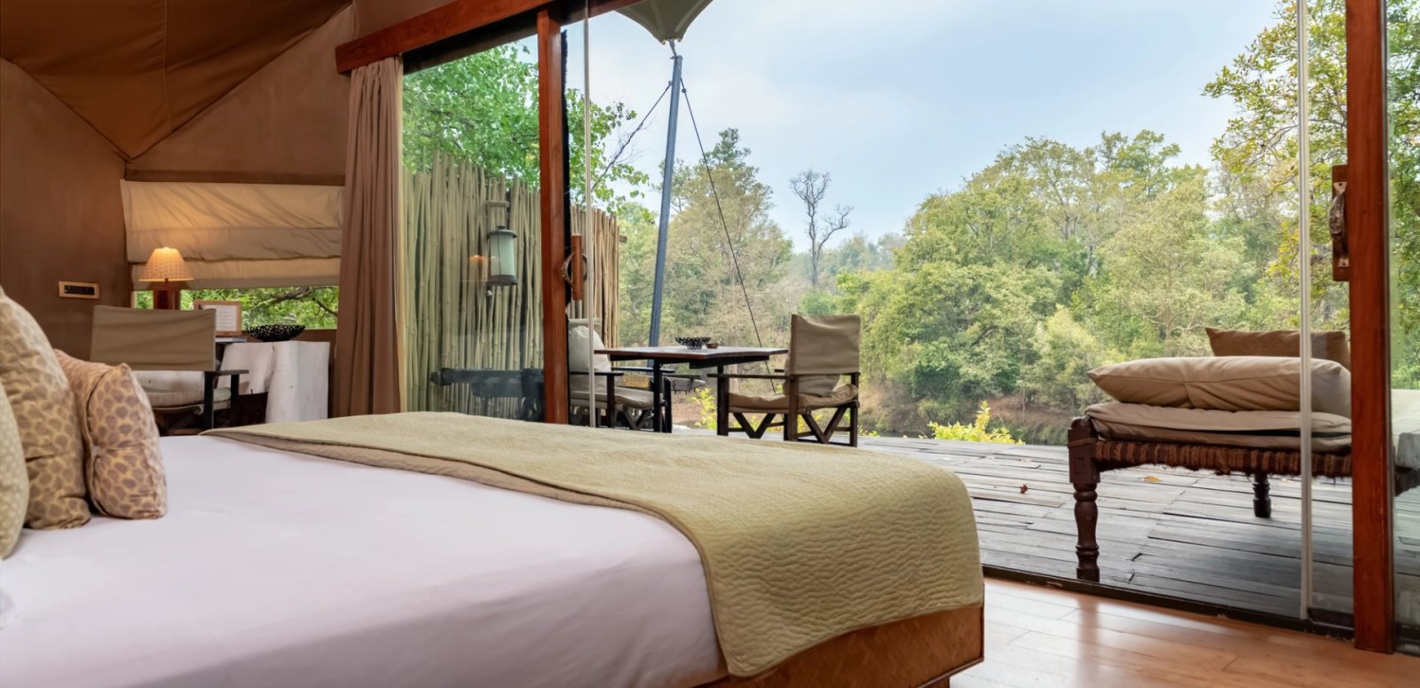 A tented suite at Banjaar Tola, Kanha, with its bed facing the forest across a private deck