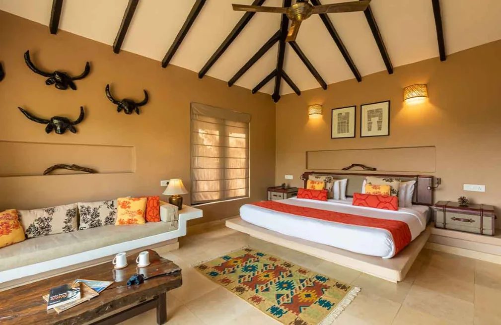 Cottage bedroom beneath a timber ceiling at Denwa Backwater Escape, Satpura