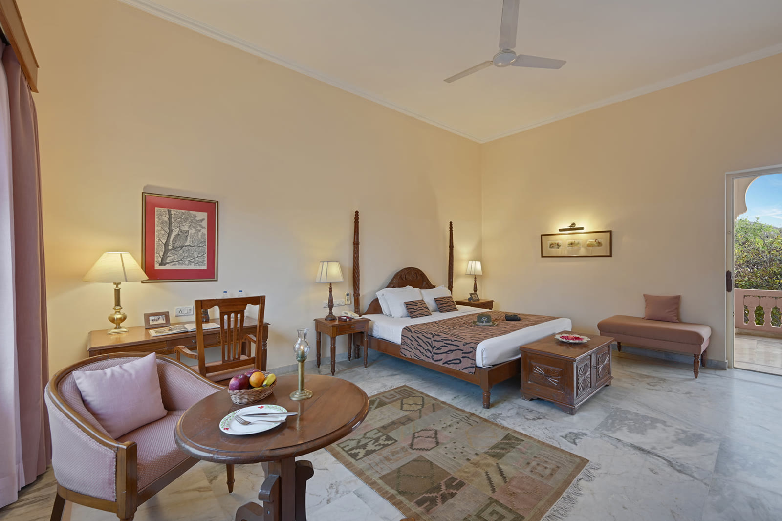 Suite at Dev Vilas, Ranthambore, with a four-poster bed and a sitting area