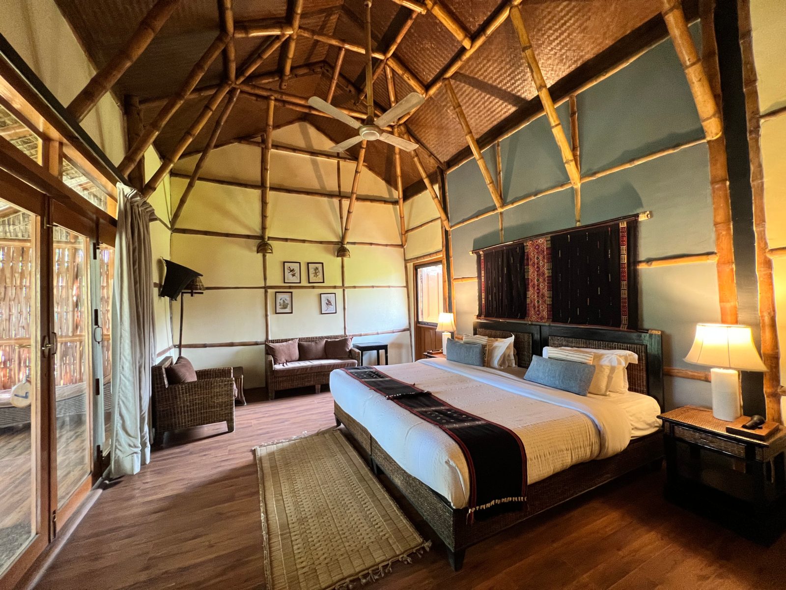Cottage bedroom with a bamboo ceiling at Diphlu River Lodge, Kaziranga