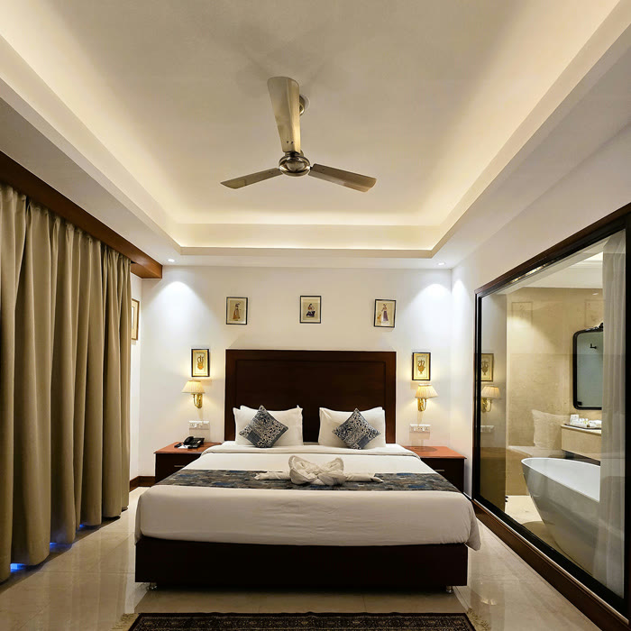 Room at Hotel Chandela, Khajuraho, with a glass wall onto the bathroom
