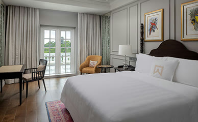 Room at ITC Windsor, Bengaluru, with French windows onto a balcony