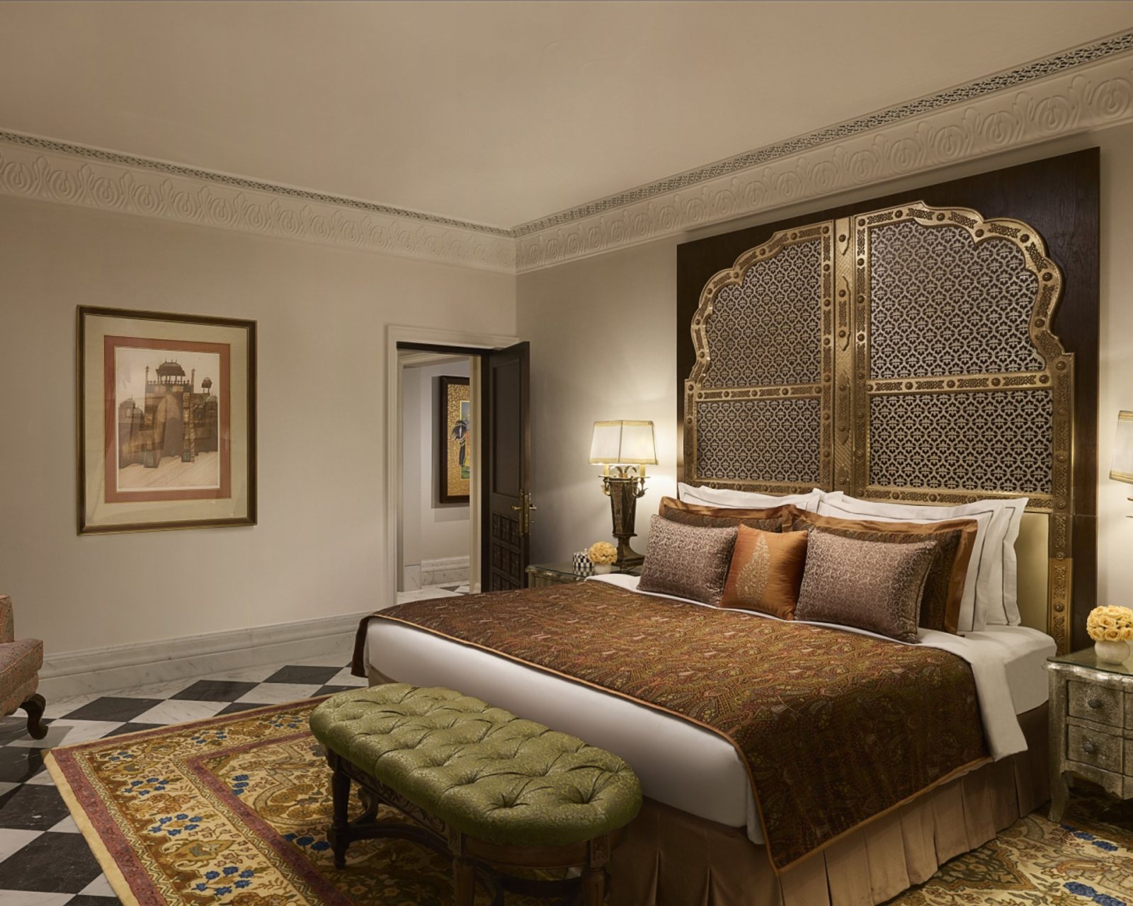 A suite bedroom at Jai Mahal Palace, Jaipur, with a carved lattice headboard