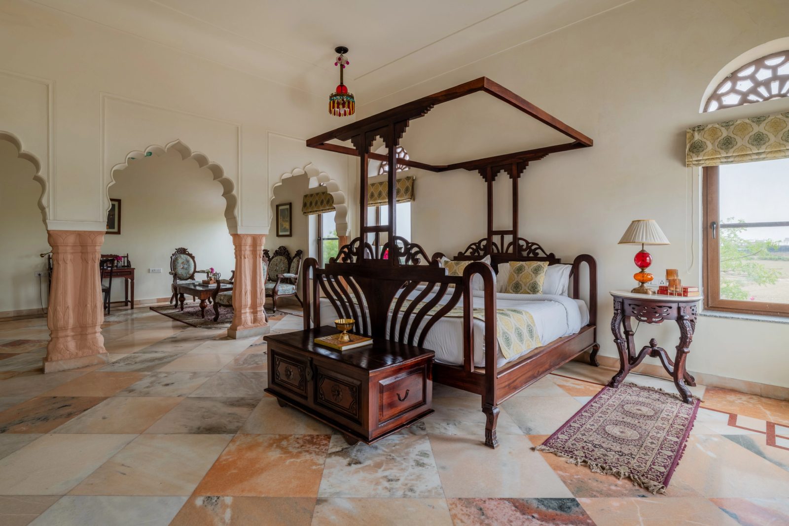 Heritage suite with a carved four-poster bed and marble floor at Laxmi Vilas Palace, Bharatpur