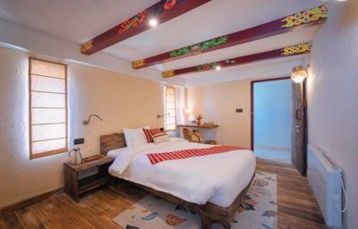 Double bedroom with painted ceiling beams at Red Panda Outpost, Singalila