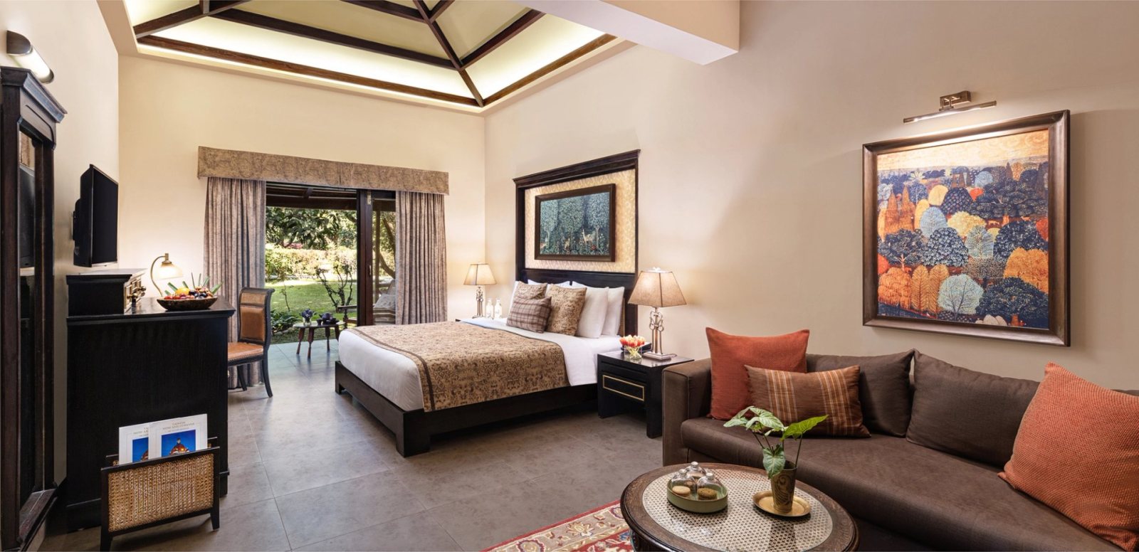 A room at Taj Corbett Resort & Spa, with doors opening onto a balcony