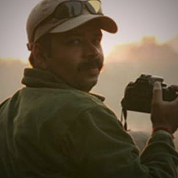 Himanshu Rathore holding a camera at dusk