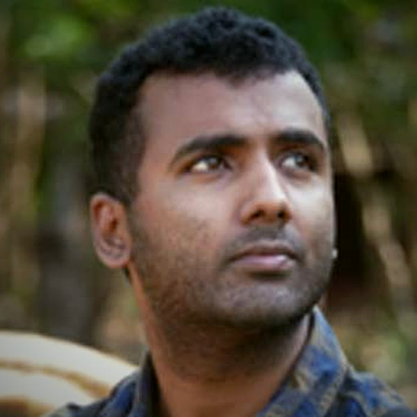 Surya Ramachandran outdoors, looking into the distance
